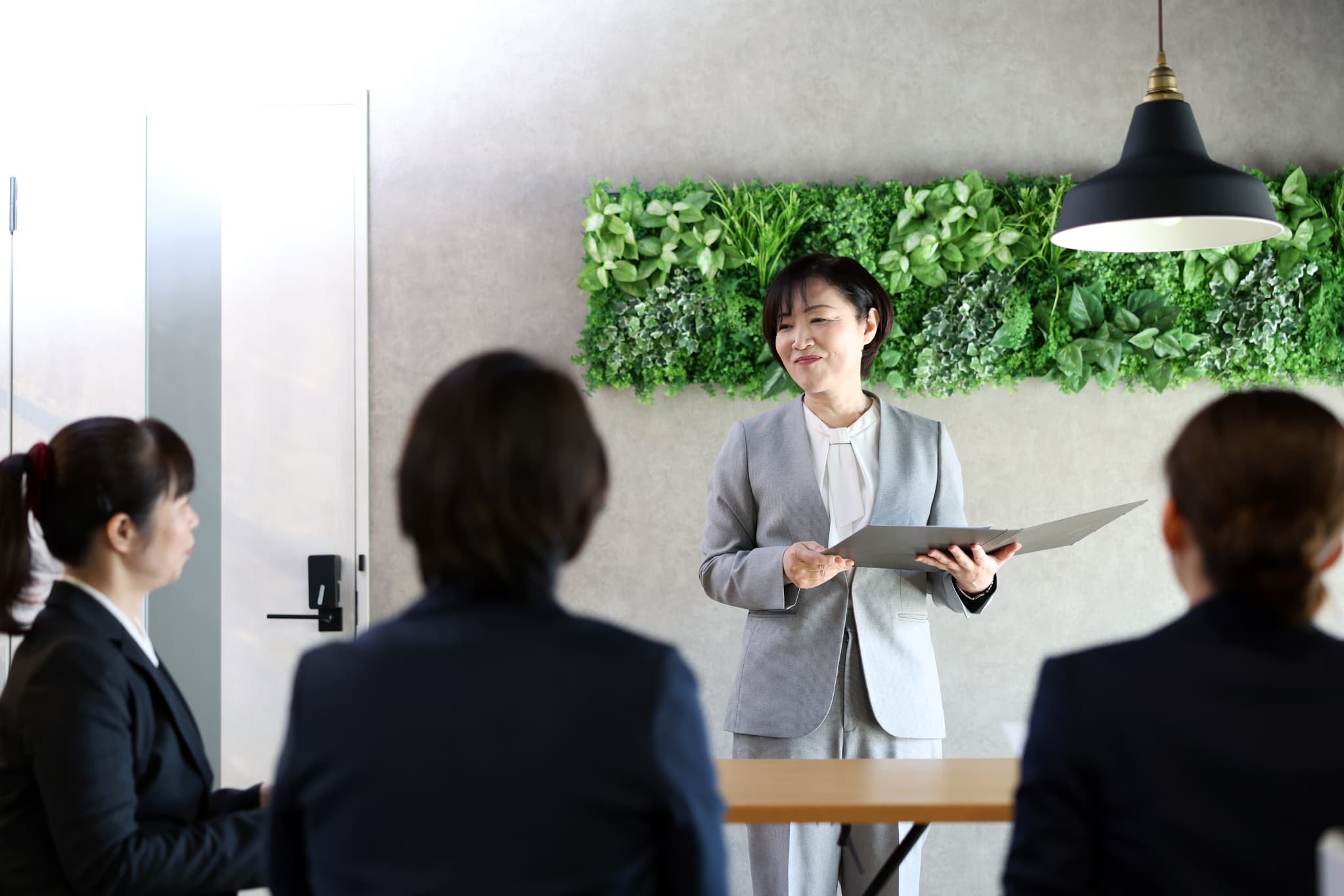 笑顔でお客様を案内する女性社員